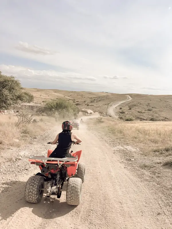 Riding a quad bike down the desert trail
