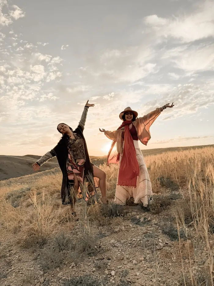 Arms open to the desert sunset