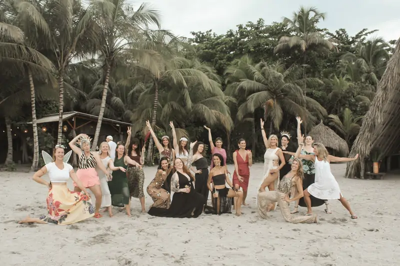 The group celebrating on the beach at dusk