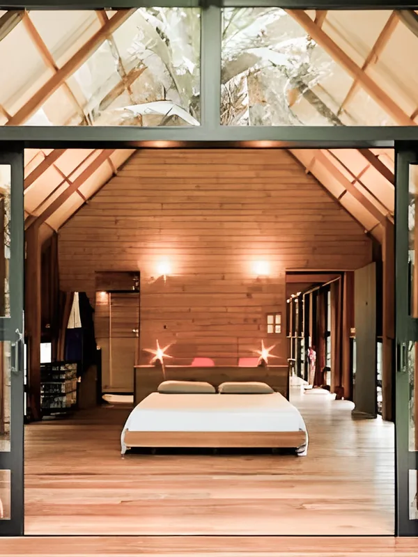 A room in wood and glass, the forest right outside