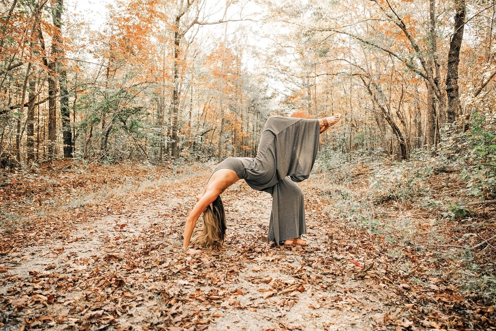 A backbend on a forest path in autumn